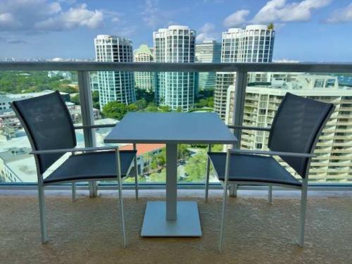 two chairs and a table on a balcony at City View Balcony steps from Restaurants, Peacock Park & Marina in Miami