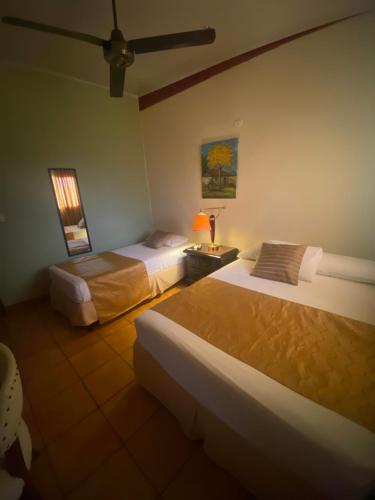a hotel room with two beds and a lamp at Hostal Fuente Castalia, B y B in León