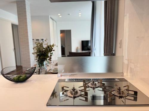 a kitchen with a stove top oven in a kitchen at Akikawa Villas 5 - Vacation STAY 18838 in Yuge