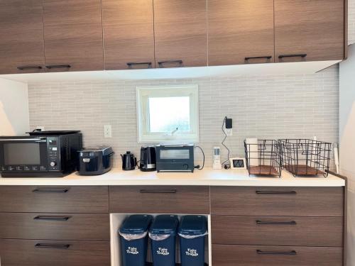 a kitchen with a counter with a microwave and appliances at Akikawa Villas 5 - Vacation STAY 18838 in Yuge
