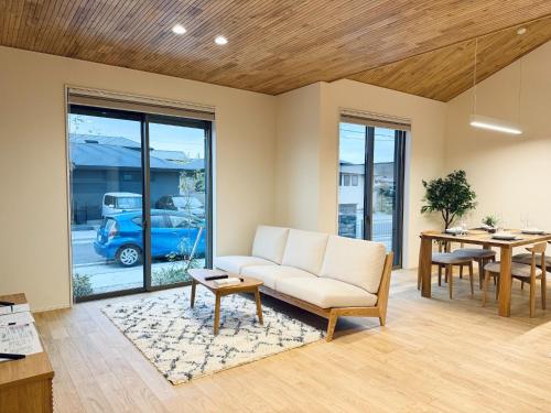 a living room with a couch and a table at Akikawa Villas 11 - Vacation STAY 18844 in Yuge
