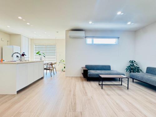 a living room with a couch and a table at Akikawa Villas 12 - Vacation STAY 18845 in Fukumoto