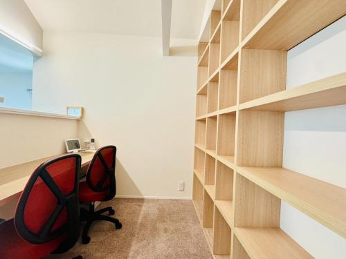 an office with a red chair and a book shelf at Akikawa Villas 12 - Vacation STAY 18845 in Fukumoto