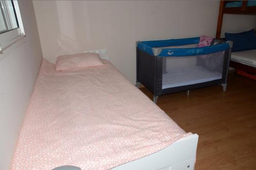 a small room with a bed and a tv at Apartment with large terrace and pool in Fès