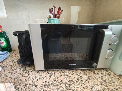 a microwave sitting on top of a counter at Rias Efthimiou House in Kanallaki