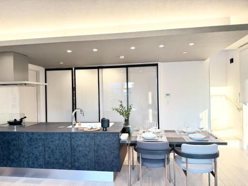 a kitchen with a large island with blue stools at Kamimashikigun - House - Vacation STAY 18866 in Takemiya