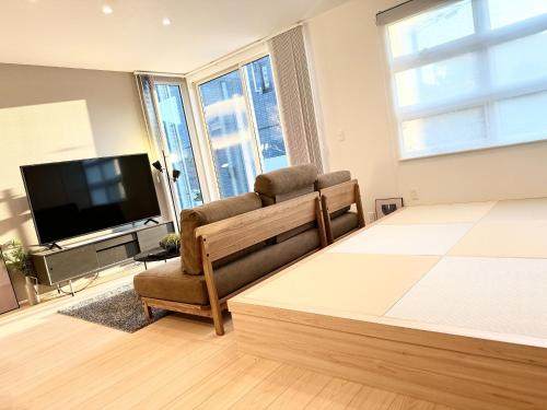 a living room with a couch and a television at Kamimashikigun - House - Vacation STAY 18866 in Takemiya