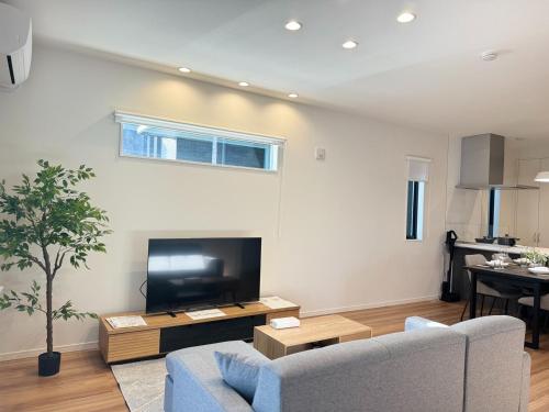 a living room with a couch and a tv at Crystal Flame Lodge Waifu 1 - Vacation STAY 18936 in Kikuchi