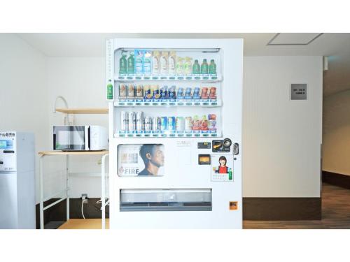 a refrigerator filled with lots of drinks in a kitchen at Smile Hotel Kumagaya - Vacation STAY 90007v in Kumagaya