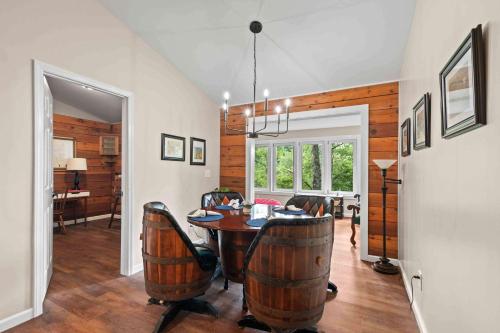 a dining room with a table and barrel chairs at Little Birds Nest in Highlands