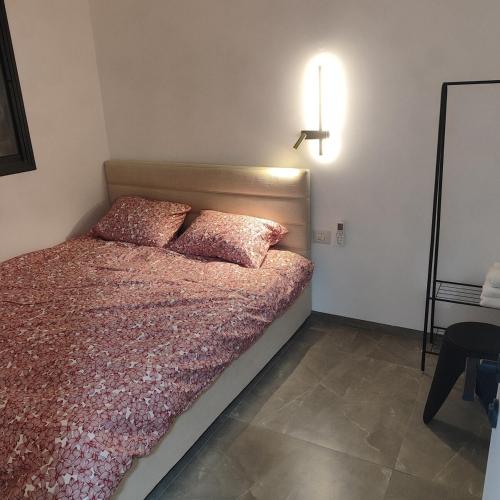 a bedroom with a bed with two pillows on it at Rell's Heart in Qiryat Shemona