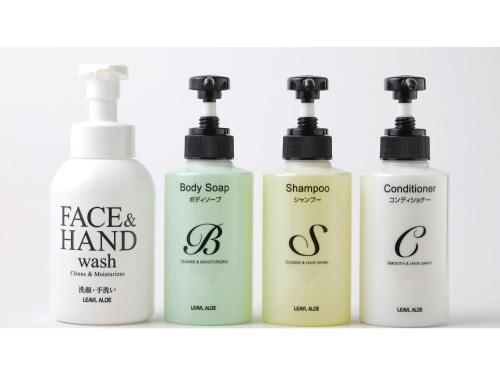 four bottles of face and hand wash on a shelf at Smile Hotel Shimonoseki - Vacation STAY 96732v in Shimonoseki