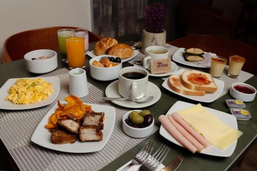 a table with plates of breakfast food on it at Rado Hotel - Quintanas in Trujillo