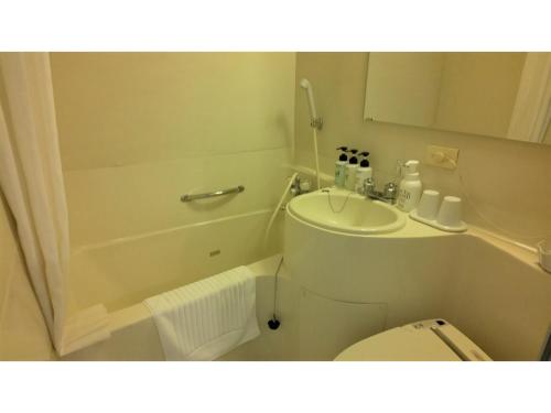 a small bathroom with a toilet and a sink at Smile Hotel Shimonoseki - Vacation STAY 93051v in Shimonoseki