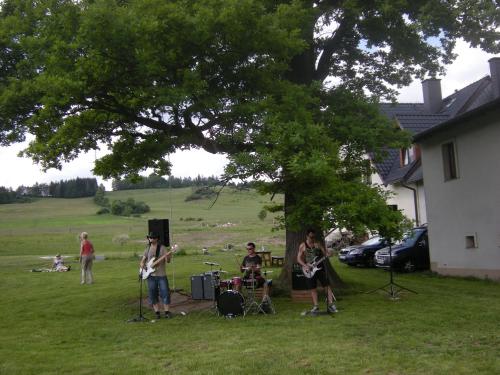 a group of people playing music in the grass at Dwa Dęby in Lubawka