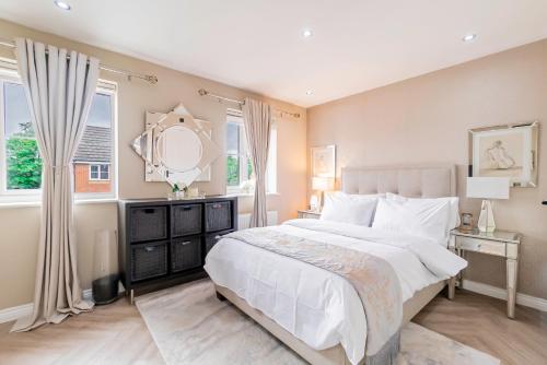 ein Schlafzimmer mit einem großen weißen Bett und einem Spiegel in der Unterkunft Three Bedroom Birmingham Stay Free Parking Perfect for Families Travellers Professionals M6 in Birmingham
