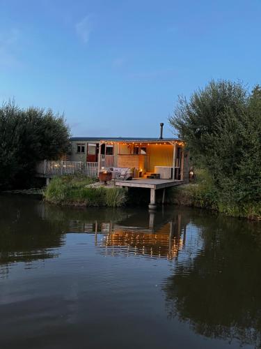 una casa sentada a orillas de un río en Herdsmans Hideaway, en Holsworthy