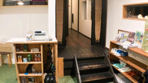 a room with a desk and a table with acomputer at Minshuku Misakiso - Vacation STAY 89790v in Miyazaki