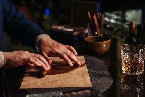 a person with their hands on a cutting board at Marriott Hotel Al Forsan, Abu Dhabi in Abu Dhabi