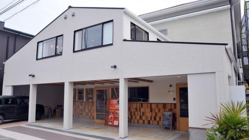 a white house with a car parked in front of it at Minshuku Misakiso - Vacation STAY 89785v in Miyazaki