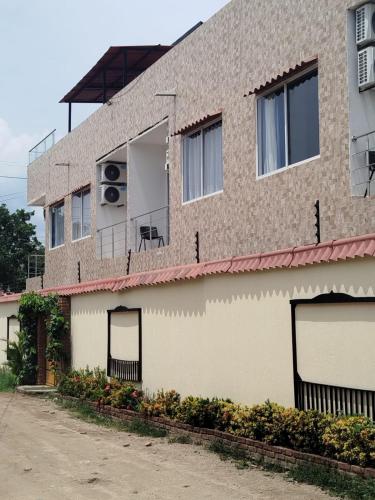 a building with a balcony with a fan on it at Apartahotel Vista hermosa Inn in Santa Marta