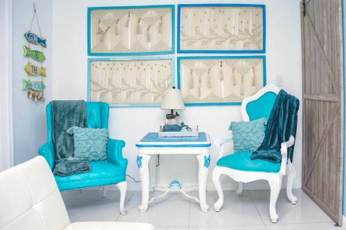 a blue and white room with two chairs and a table at Miami Family Escape in Hialeah
