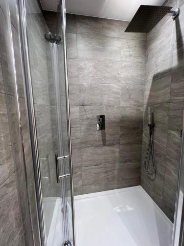 a shower with a glass door in a bathroom at Modern 2 Bedrooms apartment in Central Milton Keynes Free Parking in Milton Keynes