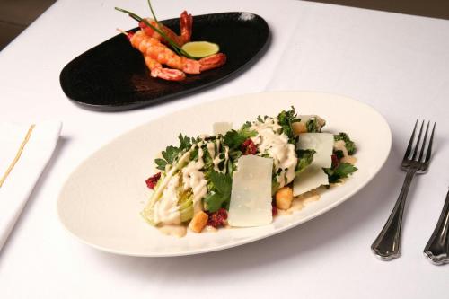 a plate of food with cheese and vegetables on a table at Sanasaryan Han, a Luxury Collection Hotel, Istanbul in Istanbul