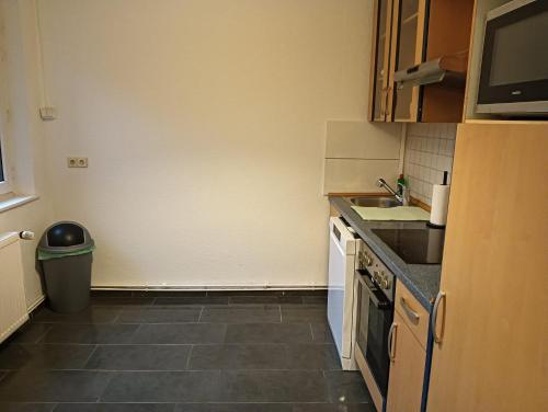 a small kitchen with a sink and a counter at Monteurswohnung Wilhelmshafen in Wilhelmshaven