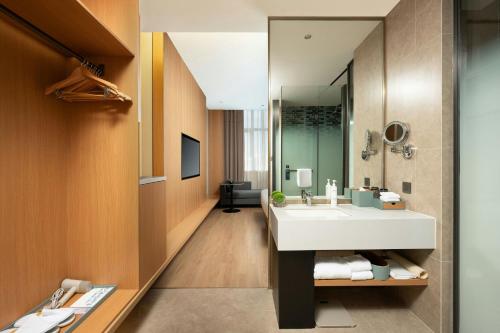 a bathroom with a sink and a mirror at Fairfield by Marriott Shanghai Hongqiao in Shanghai