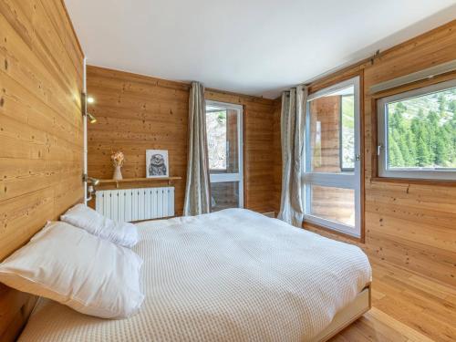 ein Schlafzimmer mit einem weißen Bett und einem Fenster in der Unterkunft Appartement spacieux au pied des pistes de Val-d'Isère avec balcon - Animaux acceptés, Wifi - FR-1-694-433 in Val dʼIsère