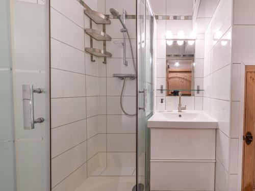 ein weißes Badezimmer mit Waschbecken und Dusche in der Unterkunft Appartement spacieux au pied des pistes de Val-d'Isère avec balcon - Animaux acceptés, Wifi - FR-1-694-433 in Val dʼIsère