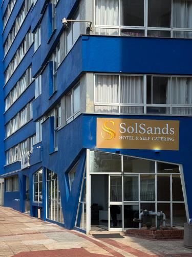 a blue building with a sign on the side of it at SolSands Hotel & Self-Catering in Durban