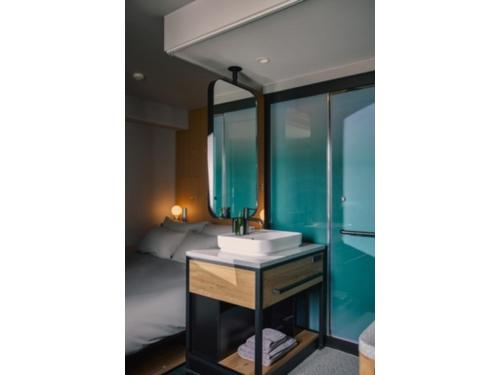 a bathroom with a sink and a mirror at BASE LAYER HOTEL NAGOYA NISHIKI - Vacation STAY 98099v in Nagoya