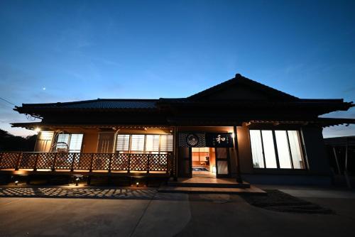 a building with a porch with lights on it at Japanese Light - Vacation STAY 00130v 