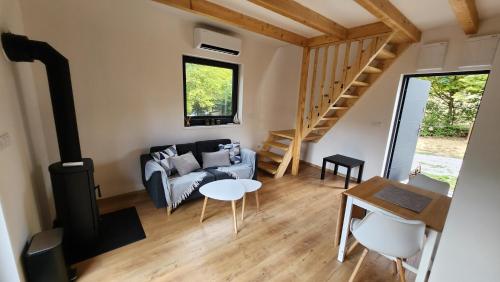 a living room with a couch and a table at Baribouda - Chaty Na Rybárně in Louka