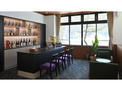 a bar with chairs and a counter in a room at Komakusa Hotel - Vacation STAY 03263v in Matsumoto