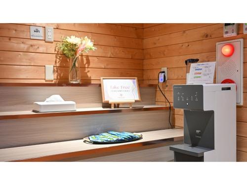 a store with wooden walls and a counter with a refrigerator at Komakusa Hotel - Vacation STAY 03263v in Matsumoto