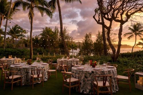 a table set up for a wedding with palm trees at The Ritz-Carlton O'ahu, Turtle Bay in Kahuku