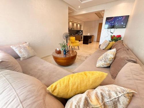 a living room with two couches and a table at cozy furnished studio fully equipped in Casablanca