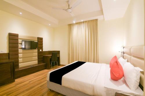 a hotel room with a bed and a flat screen tv at Super Collection O Starlight in Kānpur