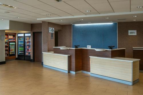 a lobby of a store with counters and a large screen at Fairfield Inn & Suites by Marriott Atmore in Atmore