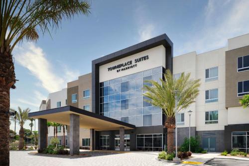 an office building with palm trees in front of it at TownePlace Suites by Marriott Ventura Oxnard in Oxnard