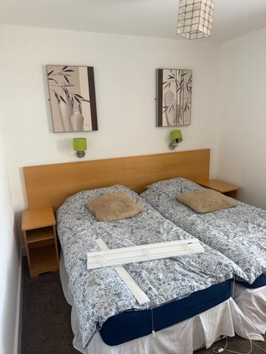 two beds in a room with two white crosses on them at Victoria Inn in Washington