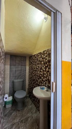 a bathroom with a toilet and a sink at Casa Cop30 green zone in Belém