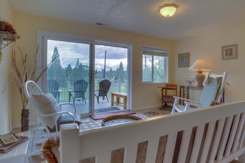 a living room with white chairs and a balcony at Bayou on the 9 in McMinnville