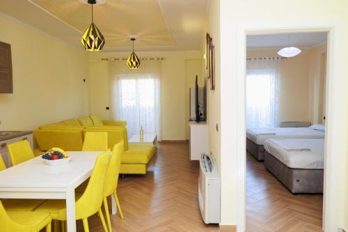 a living room with a bed and a dining room at Elena Seaview Apartment in Vlorë