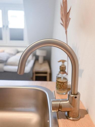 a kitchen sink with a bottle of soap on a counter at Studio No3 in Katwijk aan Zee