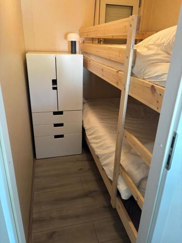 a bunk bed room with two bunk beds and a locker at Chalet Heische tip in Zeeland
