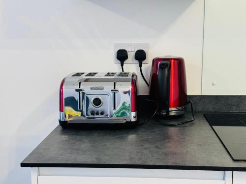 a toaster and a coffee maker on a counter at Two Bedroom Flat for Six Guests in London